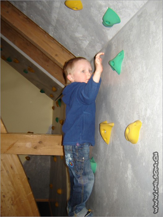 climbing up the climbing wall 